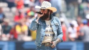 100-224800-fifa-world-cup-final-2026-ceremony-3 - عروبة الاخباري | Oroba News Male country musician performing on stage in a denim jacket and white cowboy hat, holding a microphone.