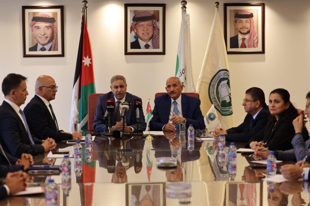 WhatsApp Image 2026-07-19 at 31545 PM3 - عروبة الاخباري | Oroba News Officials seated around a long conference table during a press briefing, with flags and portraits on the wall behind them.