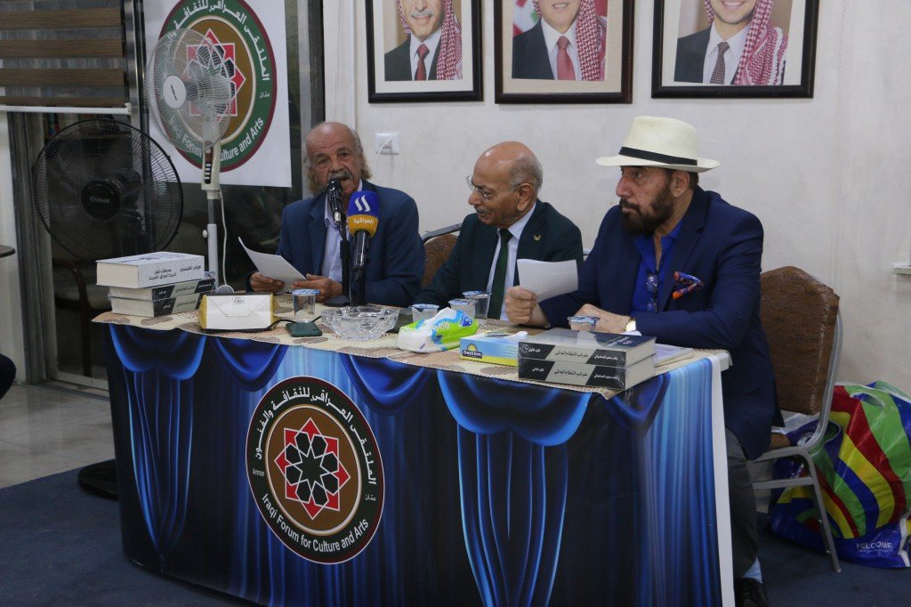 WhatsApp Image 2026-08-10 at 10910 PM - عروبة الاخباري | Oroba News Three men in suits sit at a panel table with papers and microphones, speaking at a culture and arts forum.