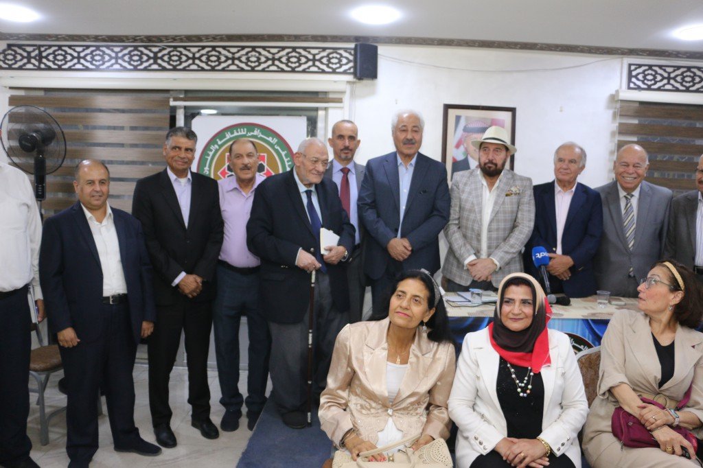 WhatsApp Image 2026-08-31 at 122528 AM - عروبة الاخباري | Oroba News Group of formally dressed men and women posing for a photo at a social or formal event, with a circular logo in the background.